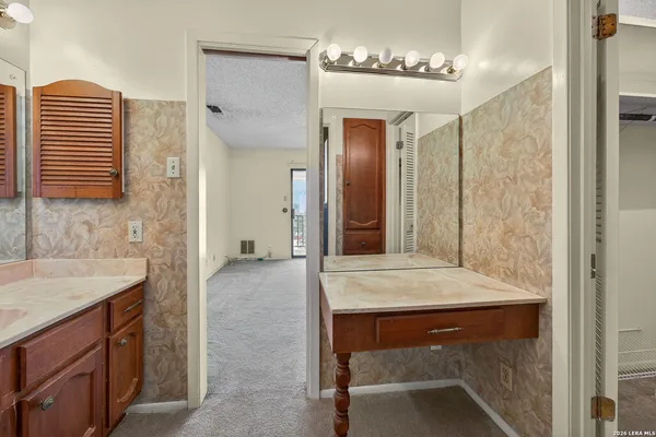 an empty room with a ceiling fan and windows