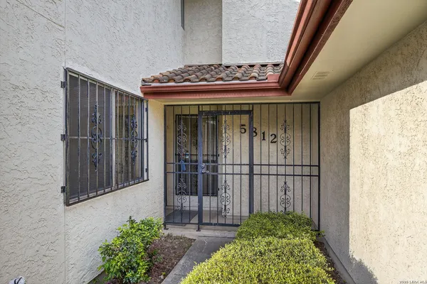 a view of an entryway with flower plants