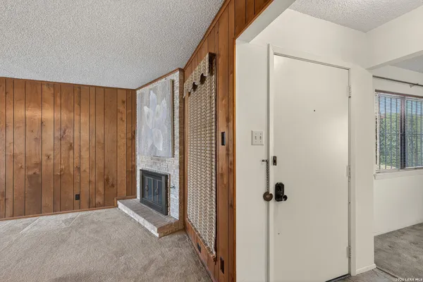 a view of a livingroom with an empty space and a fireplace