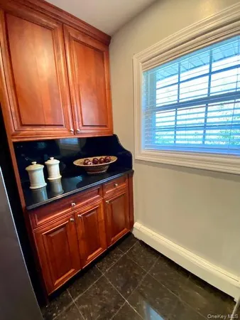 a kitchen with granite countertop cabinets and black stainless steel appliances