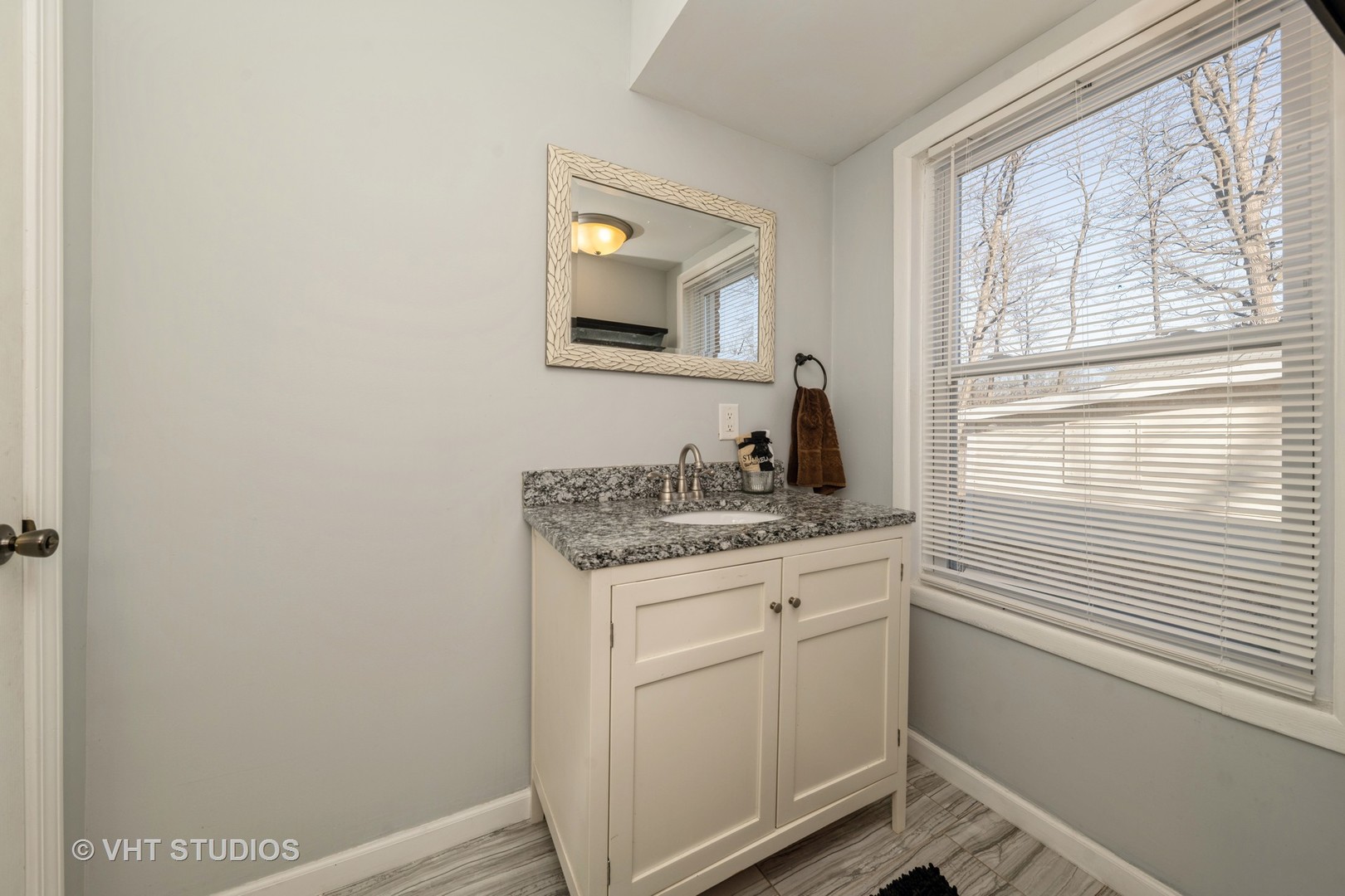 221 Cornwall Drive Crete, IL 60417 - Photo 18 of 26 a bathroom with a granite countertop sink and a window