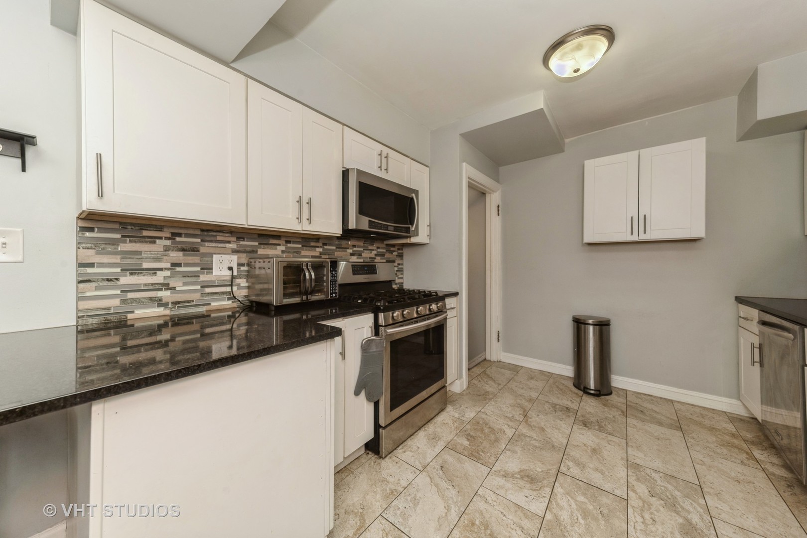 221 Cornwall Drive Crete, IL 60417 - Photo 8 of 26 a kitchen with stainless steel appliances granite countertop a stove a sink and a microwave