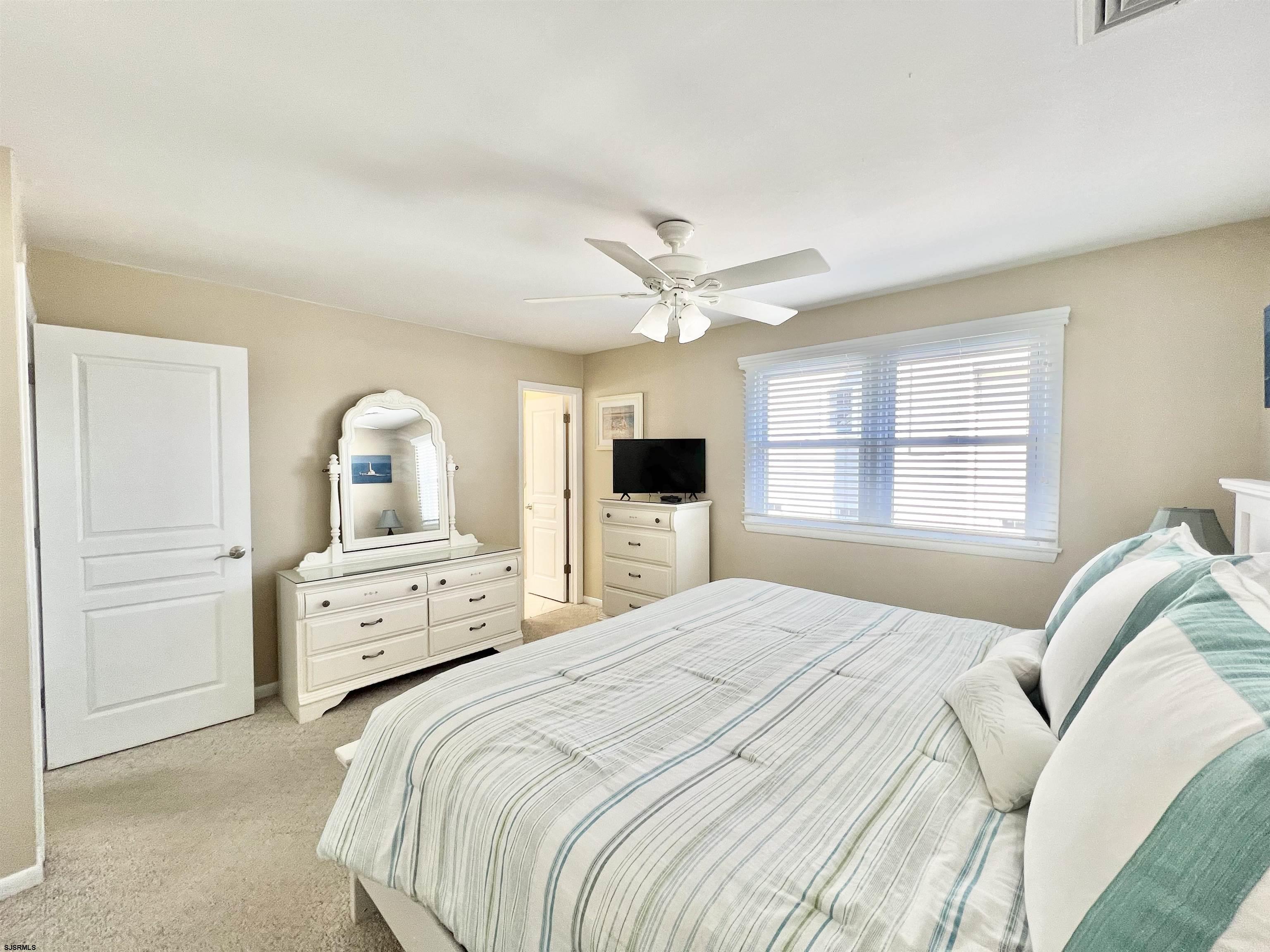 3 Simpson Road, Unit 2 Ocean City, NJ 08226 - Photo 17 of 23 a bedroom with a bed and a large window