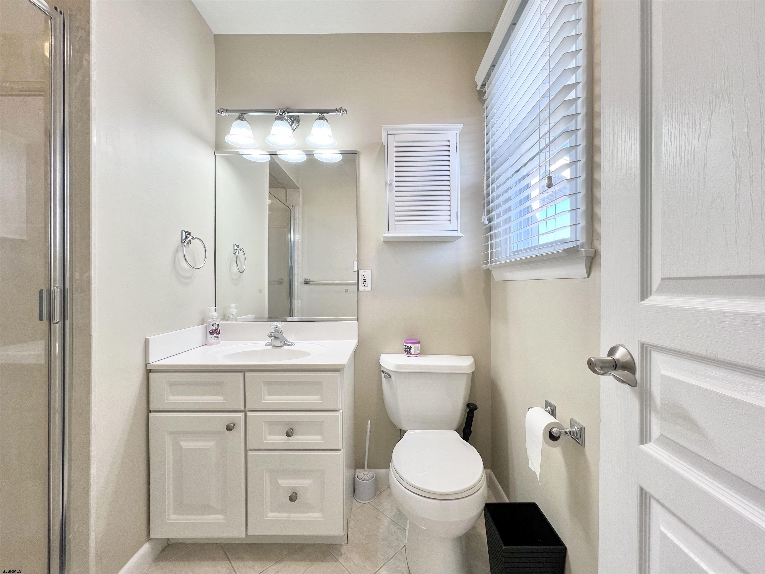 3 Simpson Road, Unit 2 Ocean City, NJ 08226 - Photo 18 of 23 a bathroom with a toilet sink and mirror