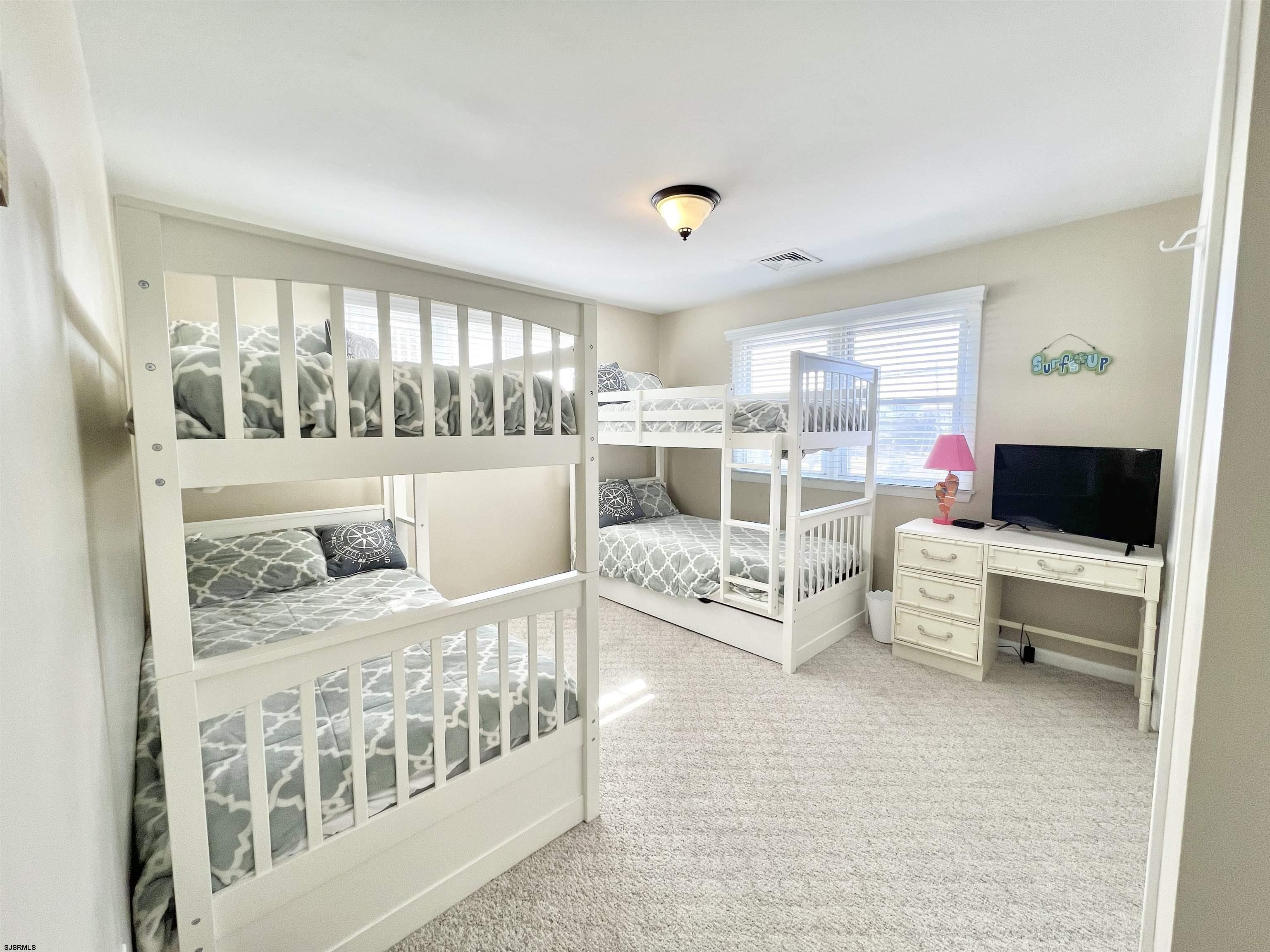 3 Simpson Road, Unit 2 Ocean City, NJ 08226 - Photo 21 of 23 a living room with furniture and a flat screen tv