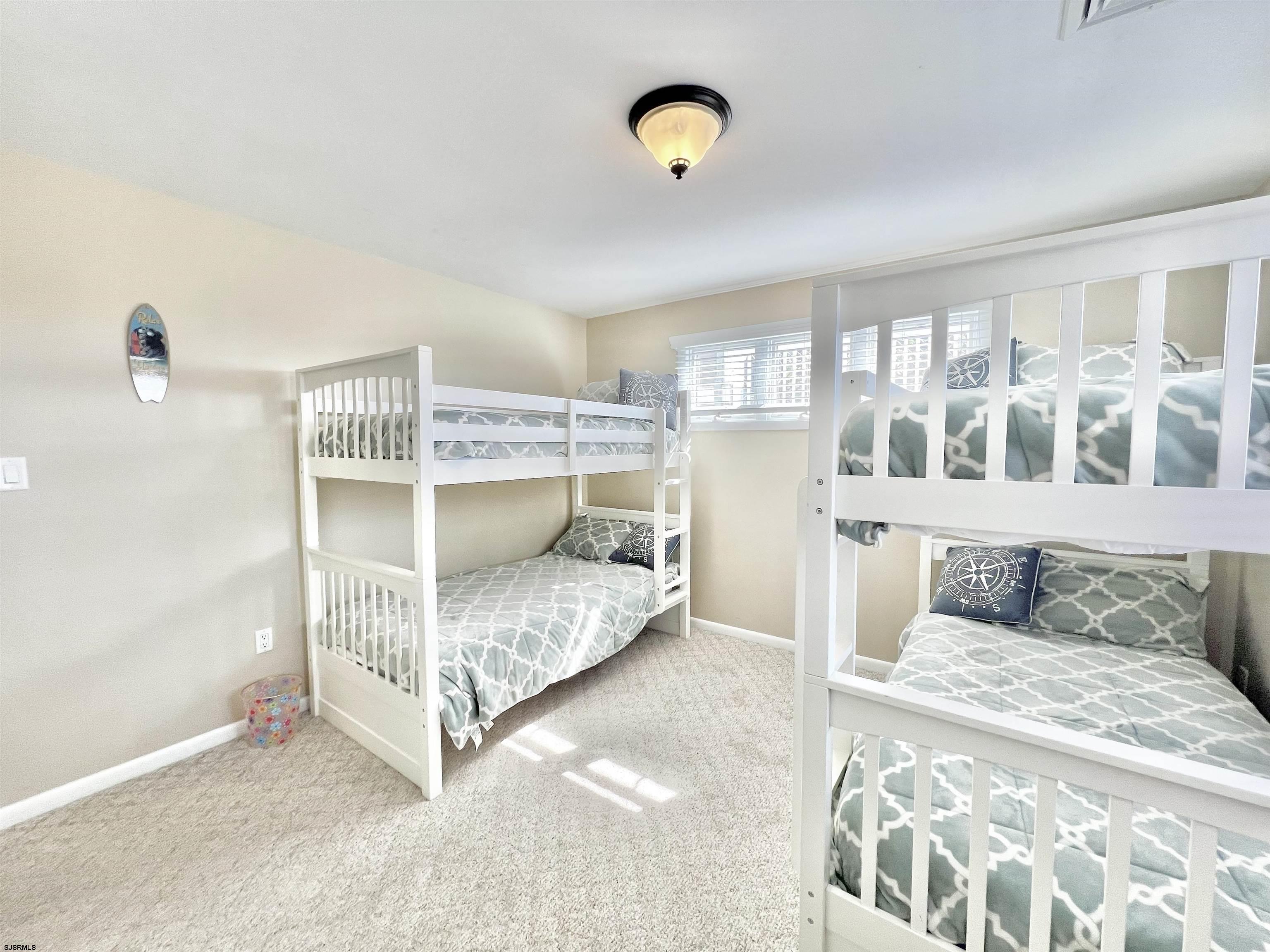 3 Simpson Road, Unit 2 Ocean City, NJ 08226 - Photo 22 of 23 a bed room with a bed and a table