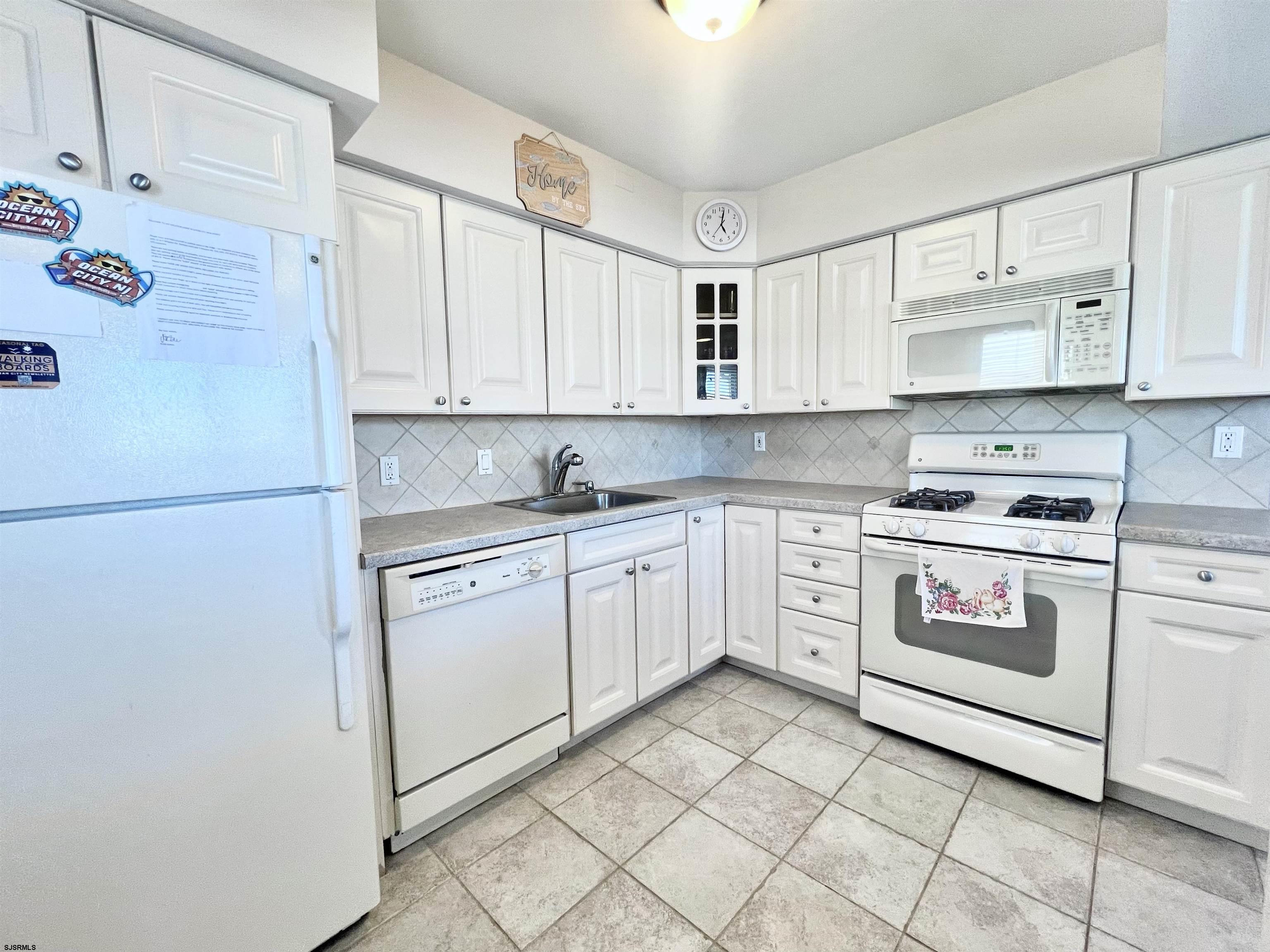 3 Simpson Road, Unit 2 Ocean City, NJ 08226 - Photo 8 of 23 a kitchen with granite countertop white cabinets and white appliances