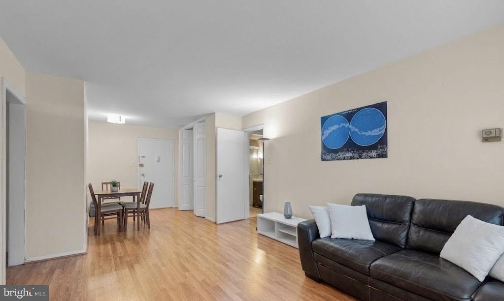 2401 H Street Northwest, Unit 211 Washington, DC 20037 - Photo 5 of 14 a living room with furniture and a wooden floor