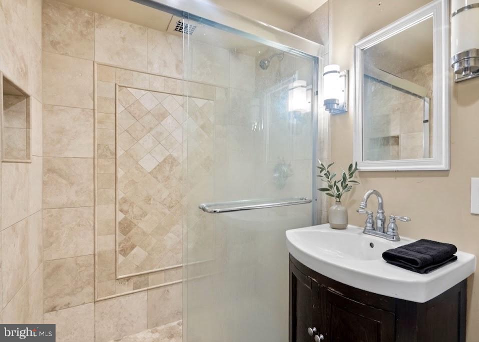 2401 H Street Northwest, Unit 211 Washington, DC 20037 - Photo 9 of 14 a bathroom with a sink and a mirror