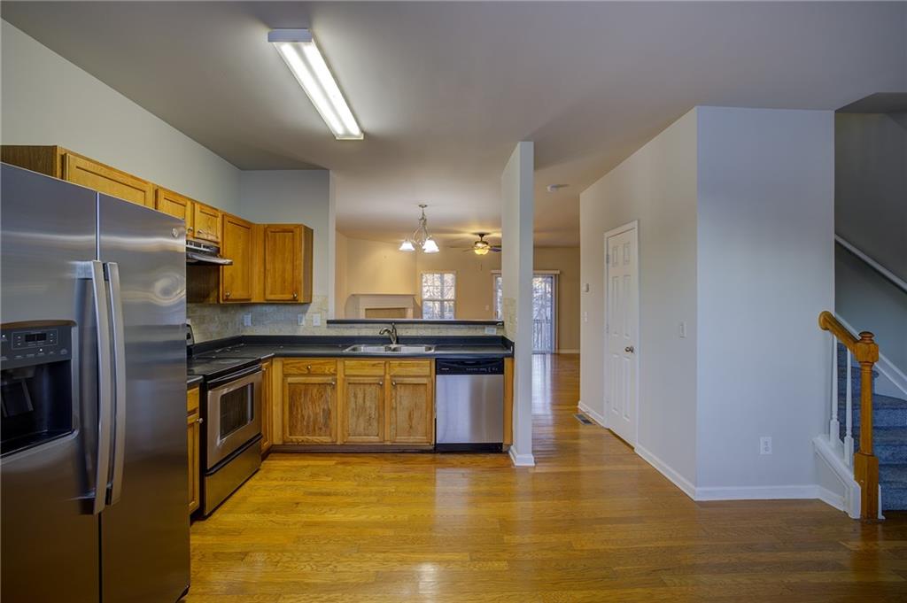 2161 Meadow Peak Road Duluth, GA 30097 - Photo 12 of 25 a kitchen with stainless steel appliances granite countertop a refrigerator a stove and a sink
