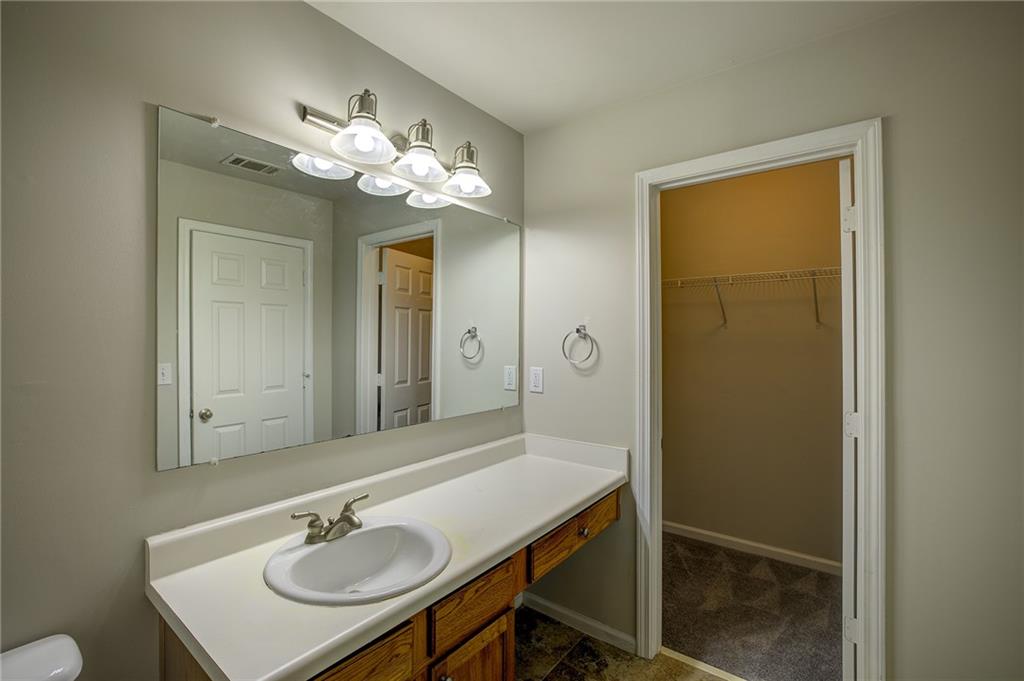2161 Meadow Peak Road Duluth, GA 30097 - Photo 18 of 25 a bathroom with a sink a light fixture and a mirror