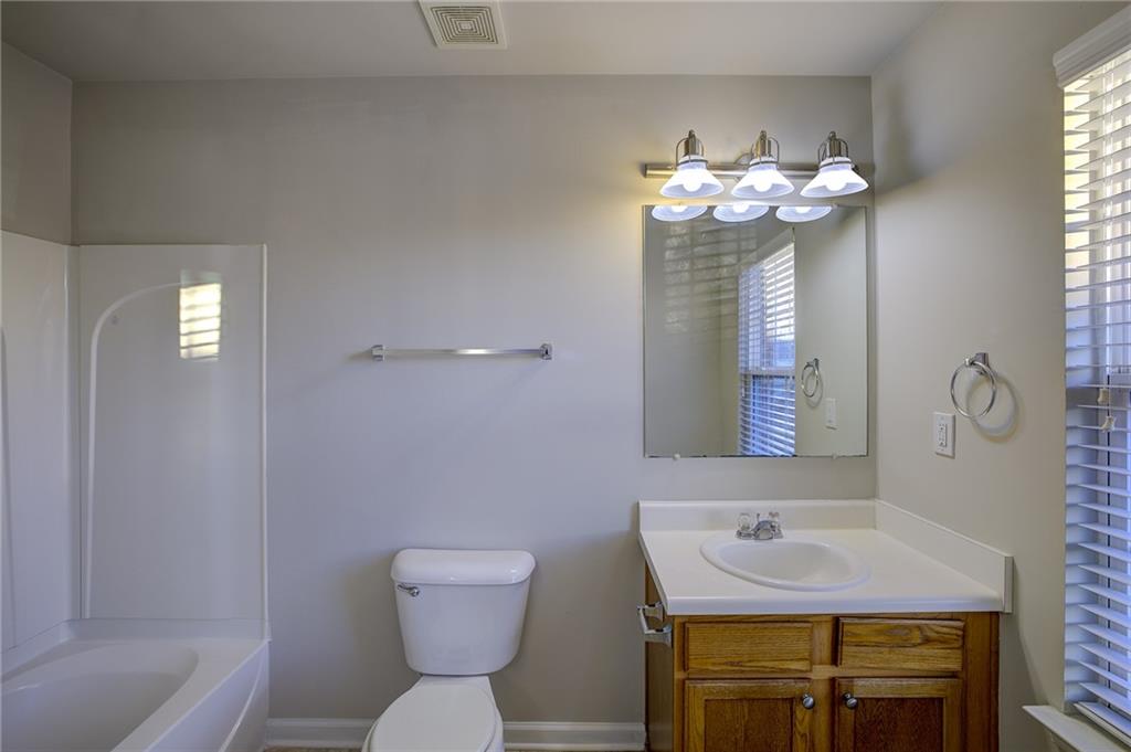 2161 Meadow Peak Road Duluth, GA 30097 - Photo 24 of 25 a bathroom with a sink mirror and toilet