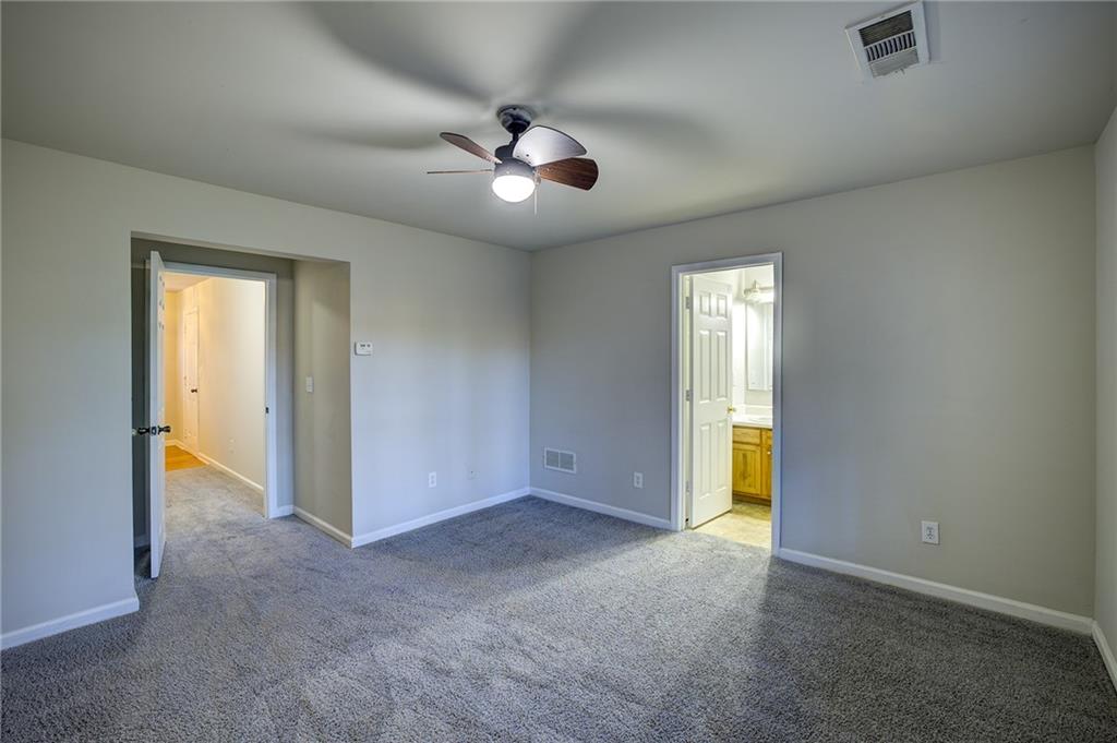 2161 Meadow Peak Road Duluth, GA 30097 - Photo 4 of 25 an empty room with chandelier fan and windows