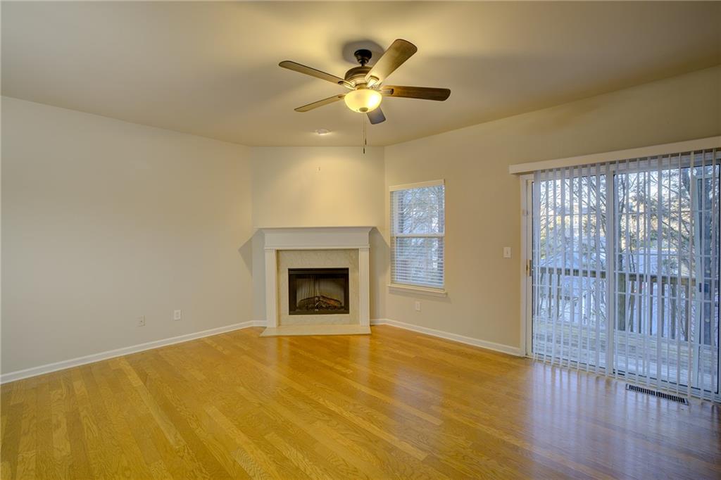2161 Meadow Peak Road Duluth, GA 30097 - Photo 7 of 25 an empty room with wooden floor fan and windows