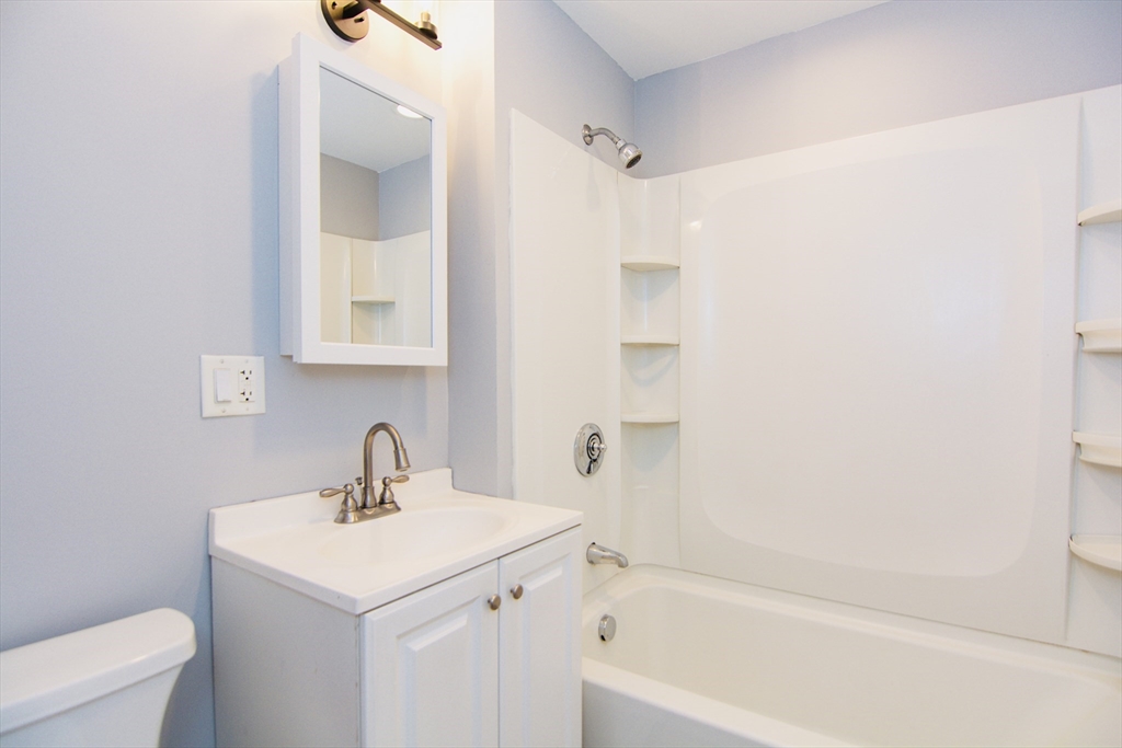 44 Cottage Street Lynn, MA 01905 - Photo 11 of 37 a bathroom with a sink a toilet and shower