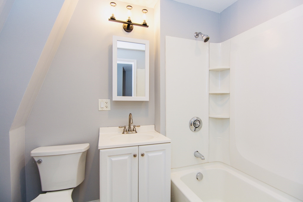 44 Cottage Street Lynn, MA 01905 - Photo 12 of 37 a bathroom with a sink a toilet and shower
