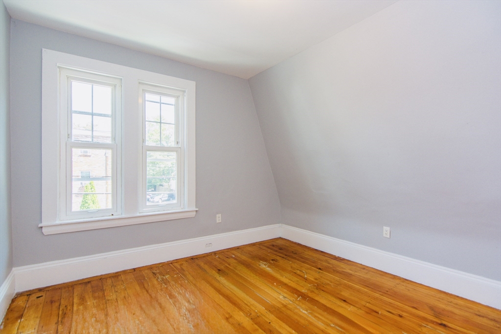 44 Cottage Street Lynn, MA 01905 - Photo 15 of 37 an empty room with wooden floor and windows