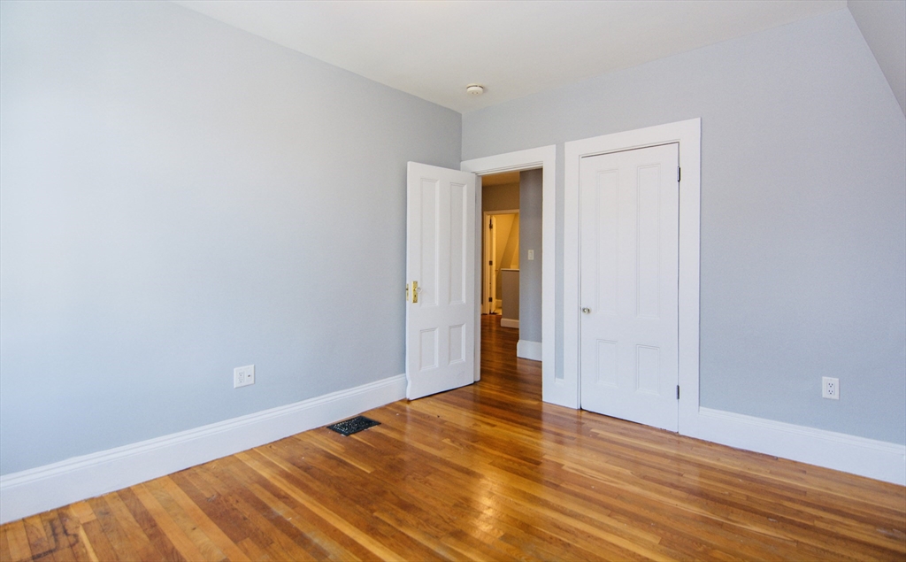 44 Cottage Street Lynn, MA 01905 - Photo 17 of 37 a view of an empty room and wooden floor