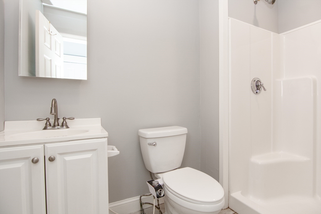 44 Cottage Street Lynn, MA 01905 - Photo 24 of 37 a white toilet sitting next to a bathroom sink
