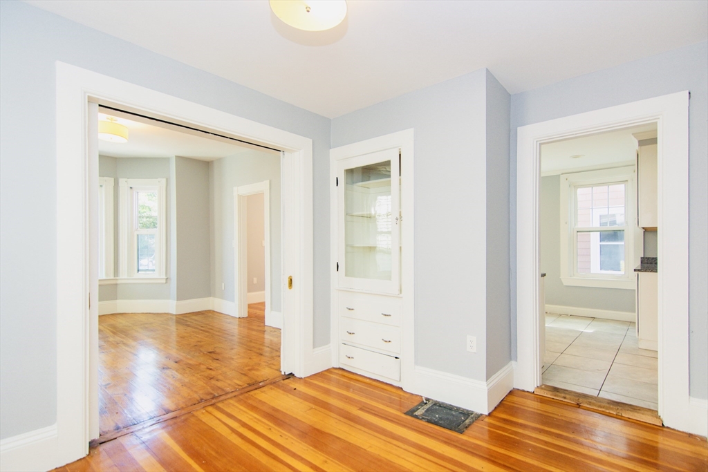 44 Cottage Street Lynn, MA 01905 - Photo 32 of 37 a bedroom with a bed and wooden floor