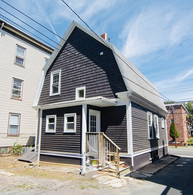 44 Cottage Street Lynn, MA 01905 - Photo 6 of 37 a front view of a house with a garage