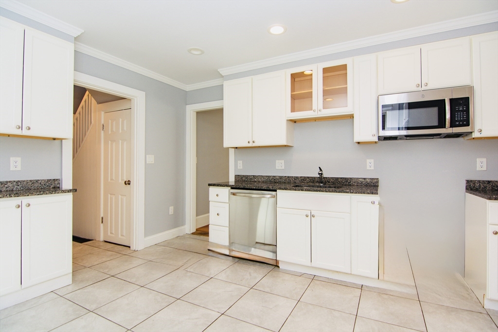 44 Cottage Street Lynn, MA 01905 - Photo 7 of 37 a kitchen with stainless steel appliances granite countertop a refrigerator and a stove top oven