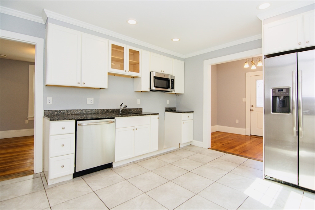 44 Cottage Street Lynn, MA 01905 - Photo 9 of 37 a large white kitchen with a sink