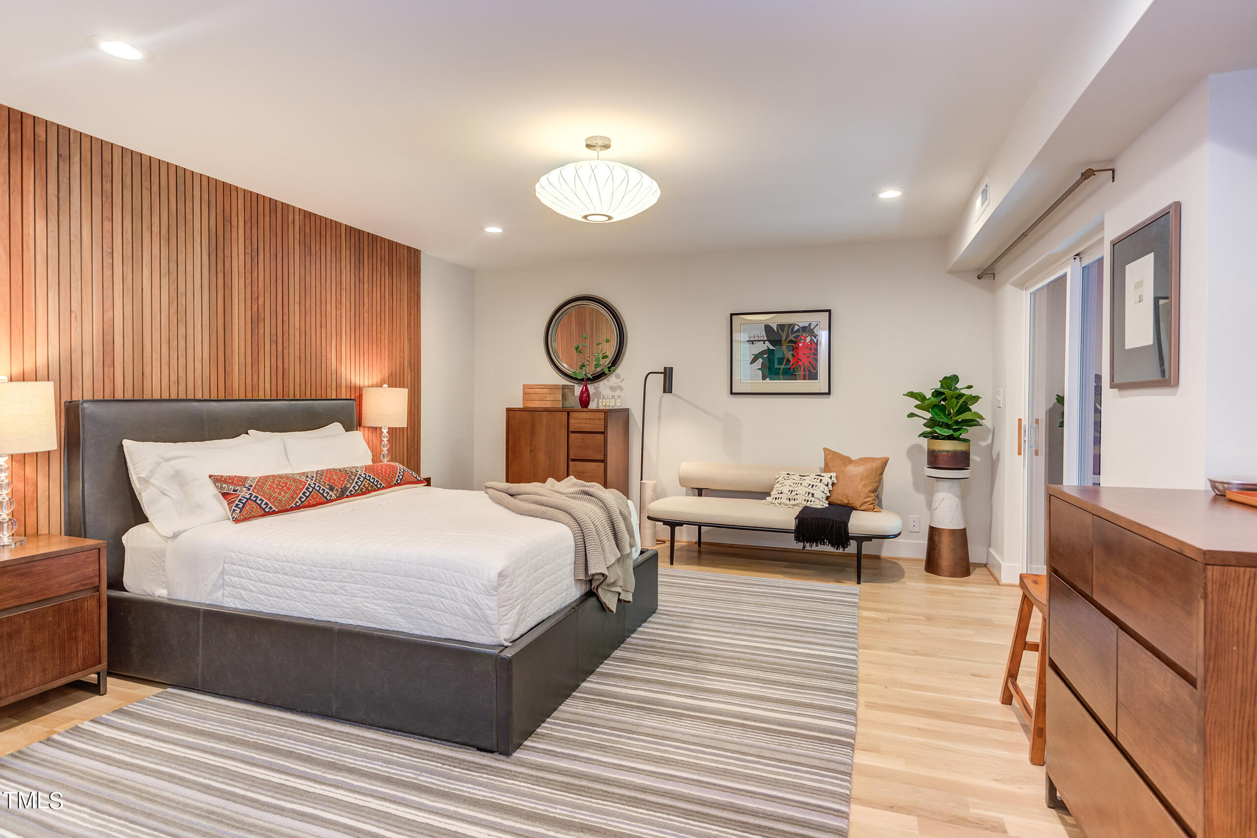 2008 Ridgewood Road Chapel Hill, NC 27516 - Photo 27 of 73 a bedroom with a large bed and a chandelier