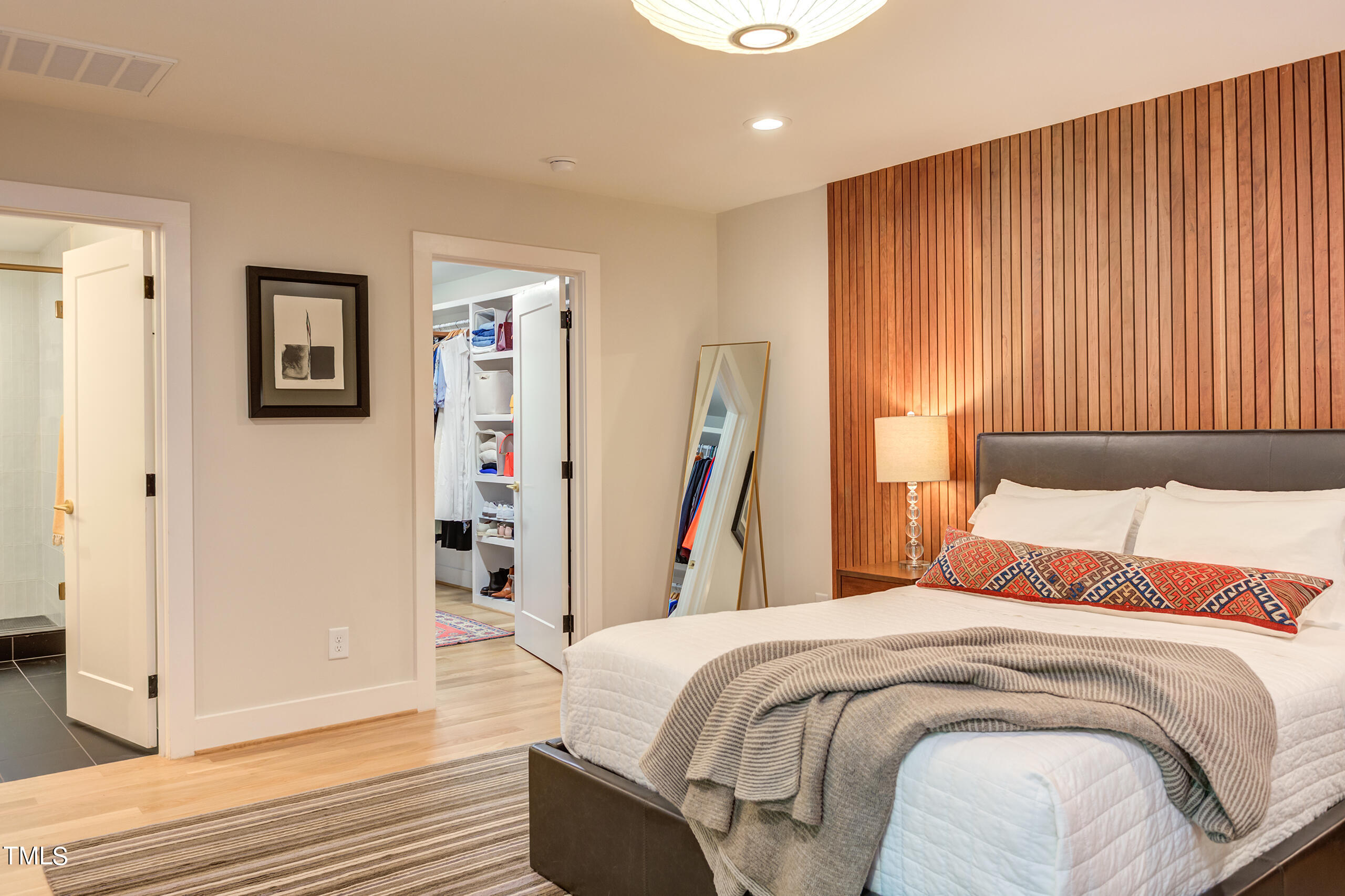 2008 Ridgewood Road Chapel Hill, NC 27516 - Photo 30 of 73 a bedroom with a large bed and a chandelier