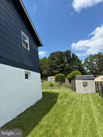 a view of a house with a yard garage and sitting area