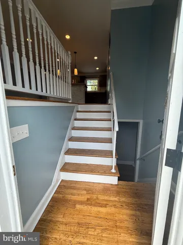 a view of entryway and hall with wooden floor