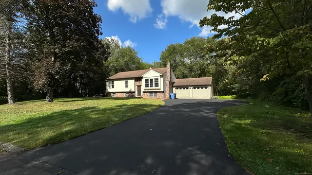 a view of a house with a yard