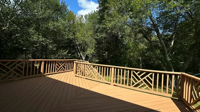 a view of balcony with wooden floor and fence