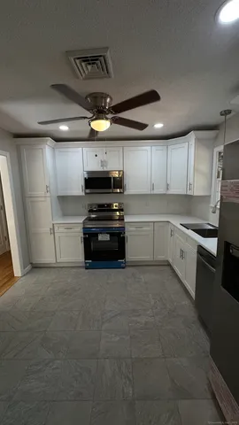 a kitchen with a stove and a refrigerator