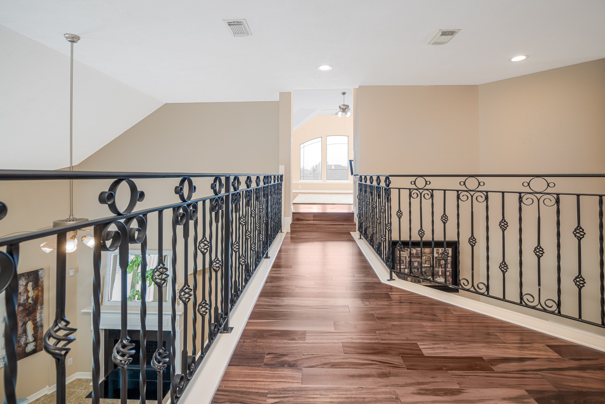 6506 Monte Bello Ridge Lane Houston, TX 77041 - Photo 14 of 39 This inviting space features elegant iron railings and rich hardwood flooring, creating a warm and stylish ambiance perfect for your new home.