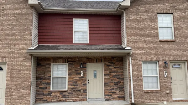 a view of a kitchen with a sink and a refrigerator