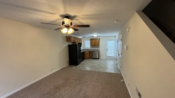a kitchen with a refrigerator stove and cabinets
