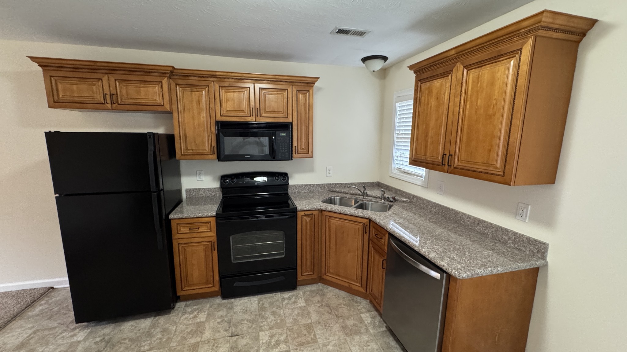 895 Branch Road Clarksville, TN 37043 - Photo 3 of 11 a kitchen with a refrigerator stove and cabinets