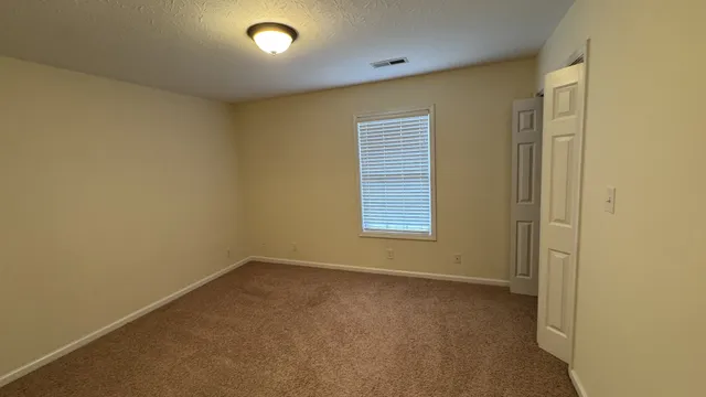 a front view of a house with parking space