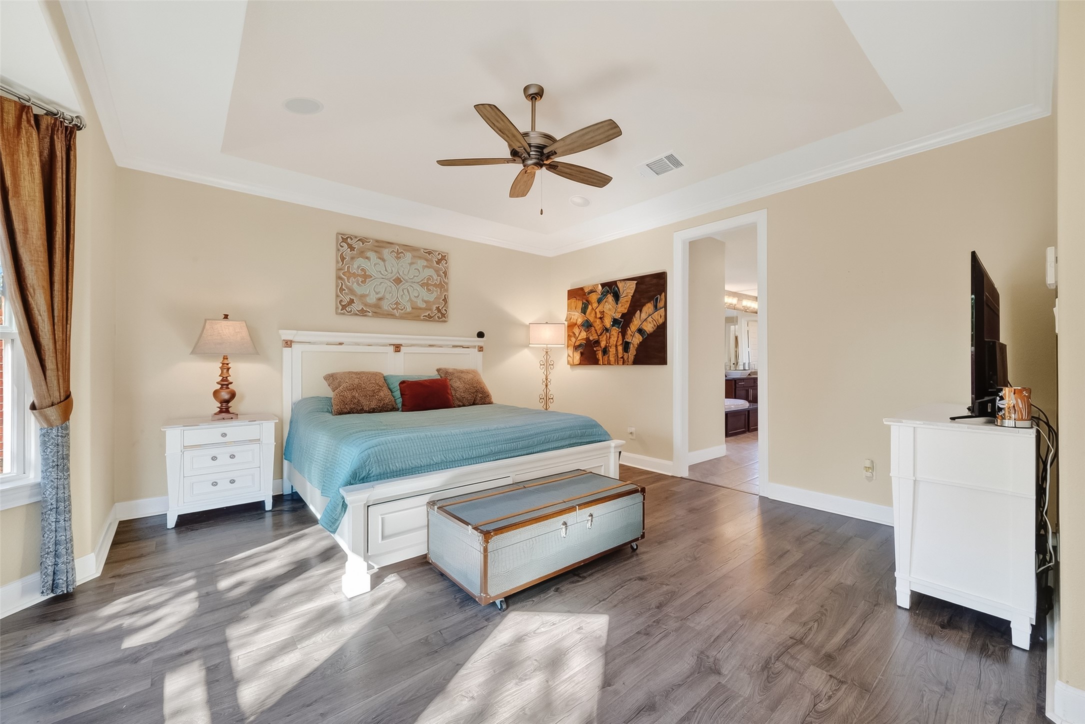 51 Scepter Ridge Sugar Land, TX 77498 - Photo 16 of 48 A view of the Primary Bedroom toward the Primary Bath. Luxury vinyl flooring, crown molding and a gambrel ceiling add style and sophistication to the suite.