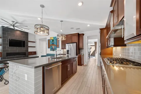 a kitchen with stainless steel appliances granite countertop a stove and a sink