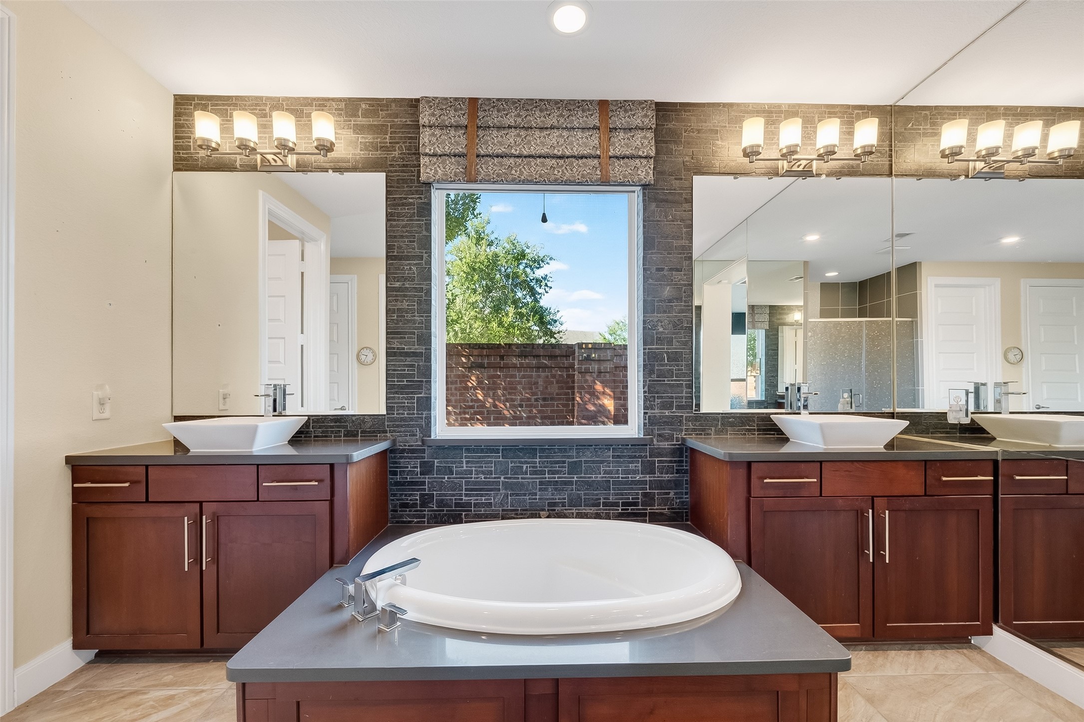 51 Scepter Ridge Sugar Land, TX 77498 - Photo 32 of 50 a bathroom with a tub a sink and mirror