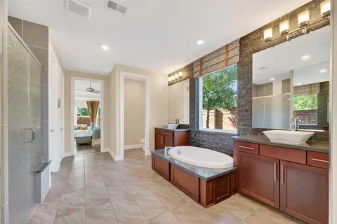 a bathroom with a tub sink and mirror