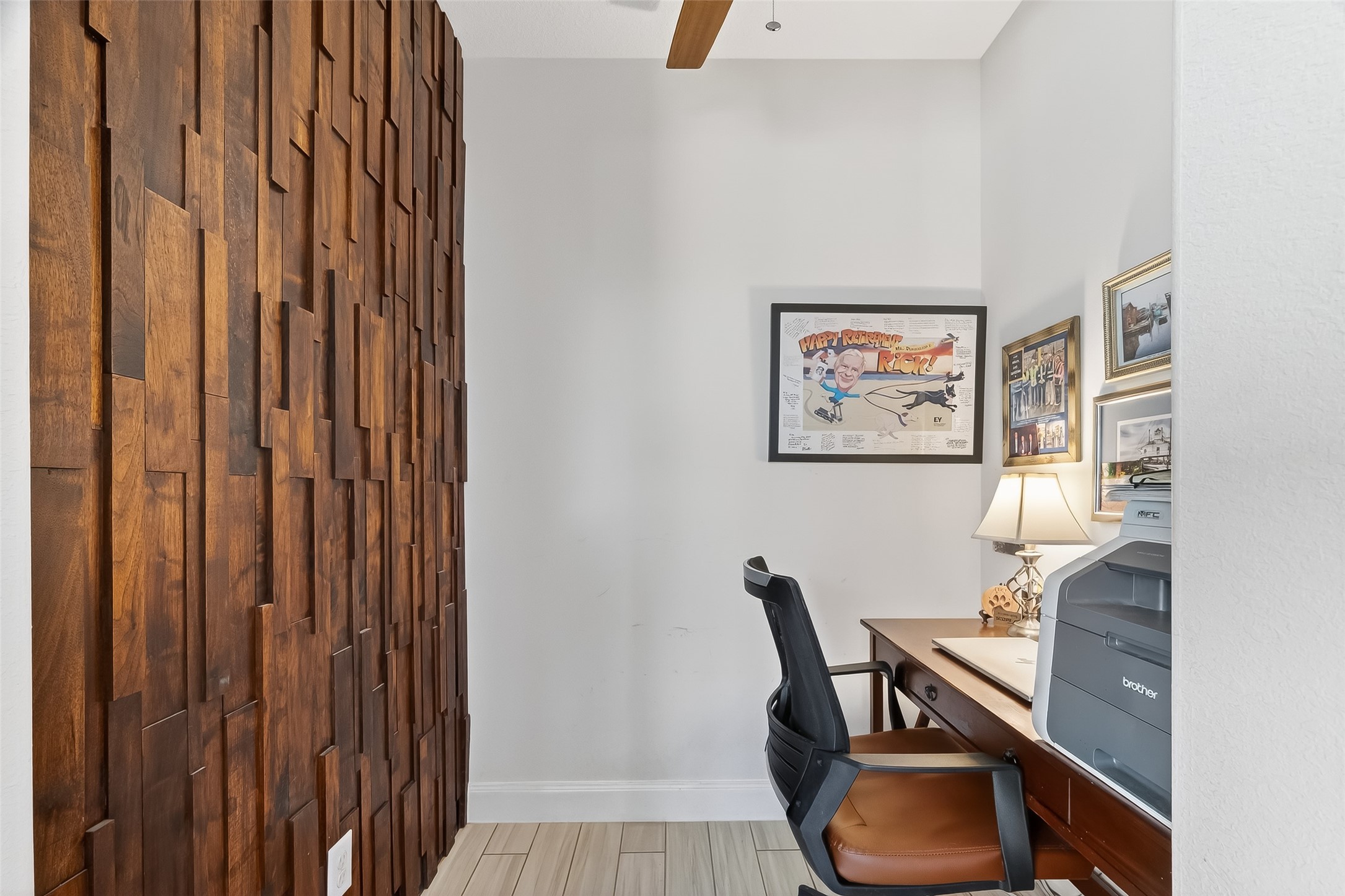 51 Scepter Ridge Sugar Land, TX 77498 - Photo 43 of 48 A sliding barn door reveals a small study or workspace nook. It’s the perfect spot to tuck away a home office, reading corner, or creative area. Perfect for a wine room, too! This cozy workspace area offers just enough room to stay productive while remaining connected to the activity of the home.