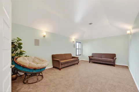 a living room with furniture and a chair
