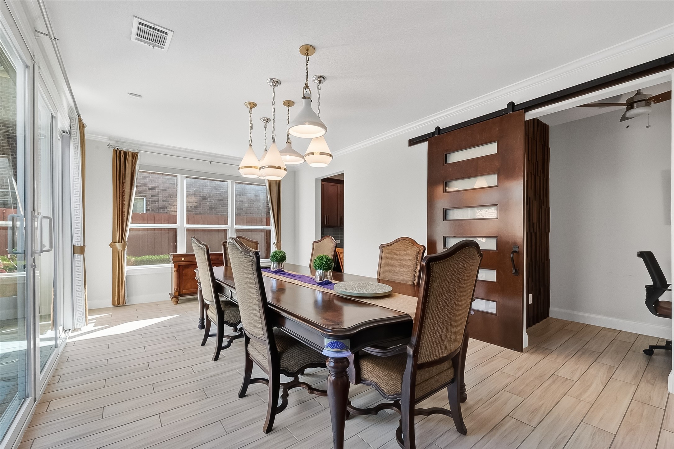 51 Scepter Ridge Sugar Land, TX 77498 - Photo 5 of 48 The Dining Room feels both elegant and comfortable. With direct access to the kitchen through the Butler's Pantry, it is easy to imagine hosting intimate meals or grand scale entertaining. Natural light bathes the space through the windows and glass doors.