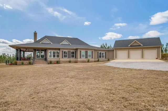 a front view of a house with a garden