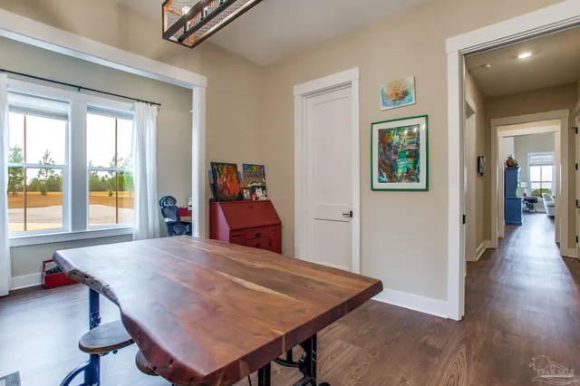a view of a dining room with furniture and a potted plant