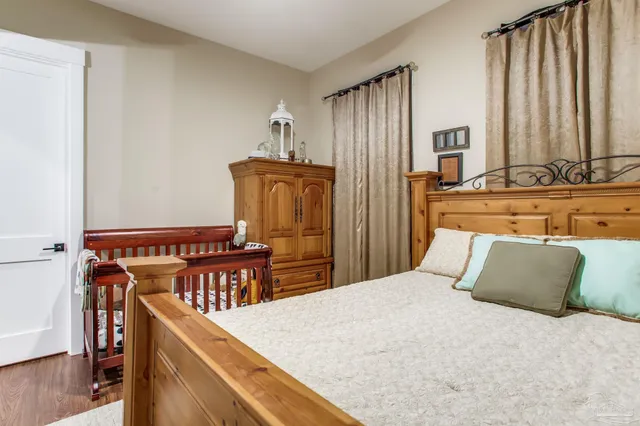 a bedroom with furniture and a large mirror