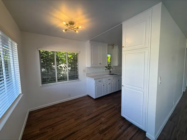 a view of a room with a hardwood and a window